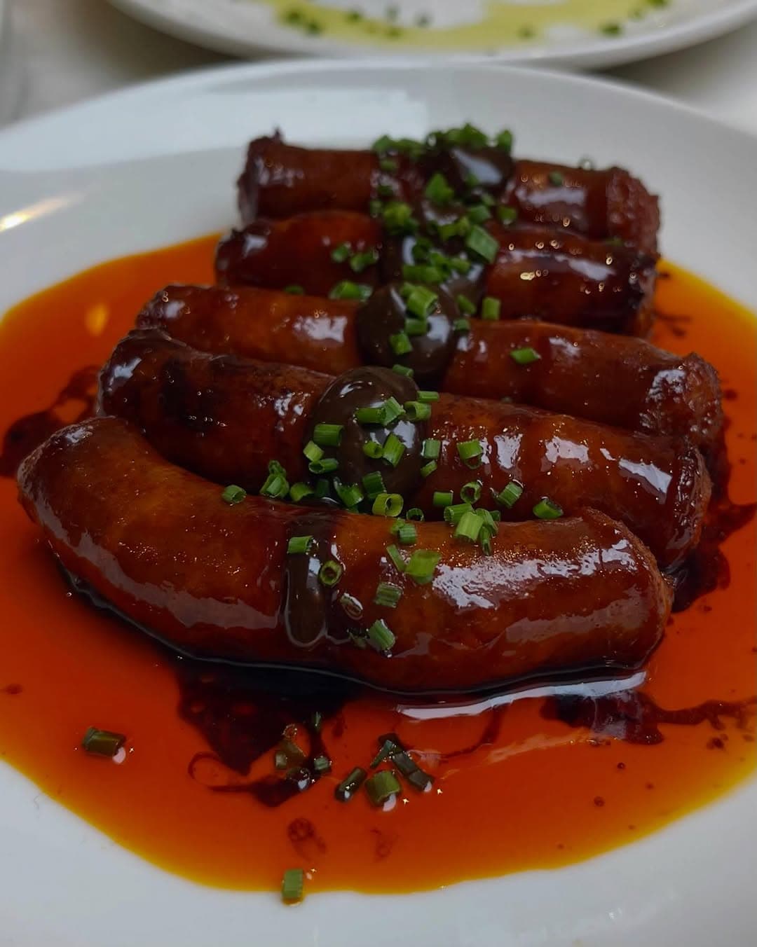 Charcoal-grilled chistorra in a glossy Pedro Ximénez sauce.