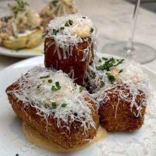 Crispy crab croquetas finished with grated pecorino.