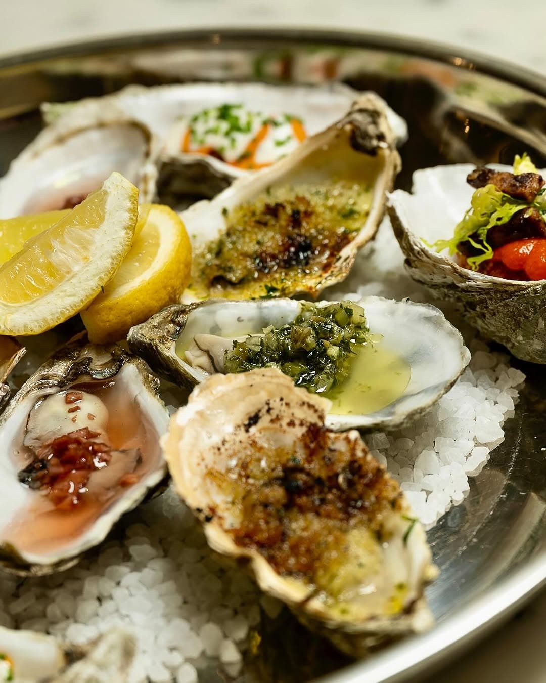 Three oysters, three ways, on rock salt.